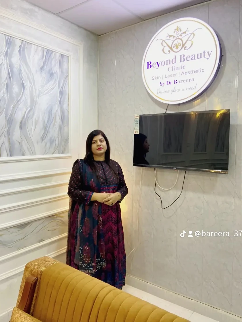Dr. Bareera Usman with framed qualifications at the clinic